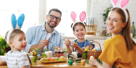 Wall Mural - happy family painting easter eggs in light kitchen