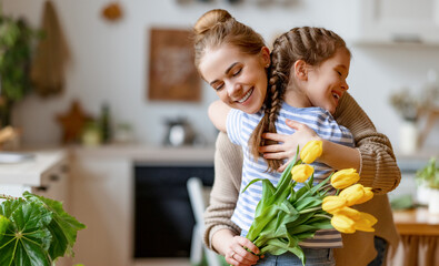 Wall Mural - happy mother receiving flowers from daughter
