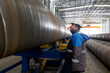 © Funtay - The quality control inpector is inspection to the welds of the spiral welded pipe in the factory.