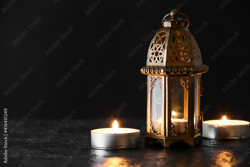 Muslim lamp and candles on dark background