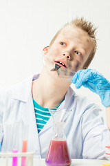 Wall Mural - funny boy dressed as chemist with dirty face after a failed experiment