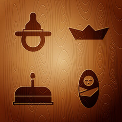 Sticker - Set Newborn baby infant swaddled, Baby dummy pacifier, Cake with burning candles and Folded paper boat on wooden background. Vector.