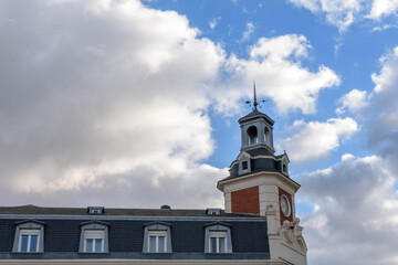 Clock building tower in the Plaza de España de Valladolíd with a blue sky with clouds. Valladolid, Castilla y Leon, Spain