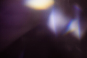 Wall Mural - blur colorful warm rainbow light leaks on black background with dust texture. defocused abstract dam