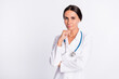 © deagreez - Photo of positive thoughtful young lady medic dressed uniform arm chin empty space isolated white color background
