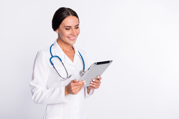 Poster - Photo of confident cheerful young lady medic dressed uniform typing looking modern device isolated white color background