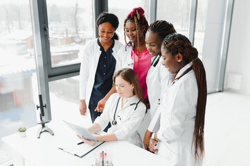 Wall Mural - confident african medical doctor and colleagues portrait in hospital