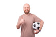 Joyful young hipster man with beard holding soccer ball and showing thumb up over white background