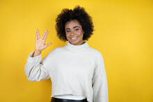 African American Woman Wearing Casual Sweater Over Yellow Background Doing Star Trek Freak Symbol