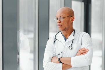 Wall Mural - friendly african american doctor in modern office