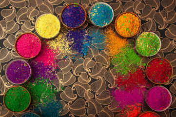 Happy Holi top view of colorful holi colors in bowls with Splash, Concept Indian color festival. 