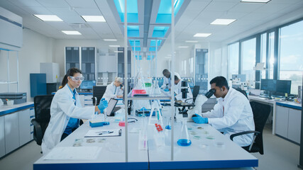 Wall Mural - modern medical research laboratory: diverse team of scientists working using microscope, analysing b
