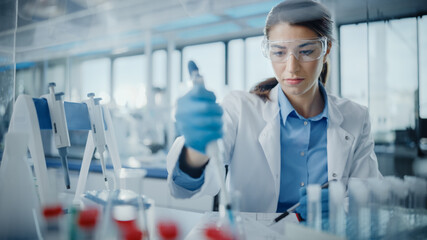 Wall Mural - Medical Research Laboratory: Portrait of a Beautiful Female Scientist in Goggles Using Micro Pipette for Test Analysis. Advanced Scientific Lab for Medicine, Biotechnology, Microbiology Development