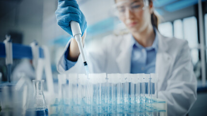 Medical Research Laboratory: Portrait of a Beautiful Female Scientist in Goggles Using Micro Pipette for Test Analysis. Advanced Scientific Lab for Medicine, Biotechnology, Microbiology Development