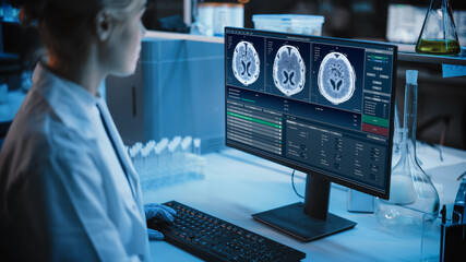 Wall Mural - Medical Research Laboratory: Portrait of Female Scientist Working on Computer Showing MRI Brain Scans. Advanced Scientific Lab for Medicine, Cancer Development. Dark Blue Shot