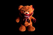 scary bear with a creepy bloody grin on a black background. horror toy. halloween concept. a severed paw and a bitten off ear covered in blood