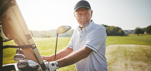 Smiling senior man ready to play a round of golf