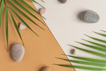Zen Flat Lay Composition With Green Leafs And Stones. Tropical Leaf And Sea Pebble On Beige Background. Spa Or Beauty Template With Place For Text Or Product . Blank Card With Tropical Leaves.