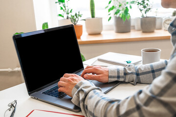 Wall Mural - a young male programmer uses a laptop and types code in the office. software, programming concept