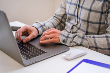 Canvas Print - men's hands typing on a laptop keyboard, a business concept of working in the office as a programmer