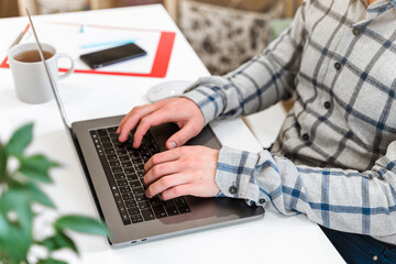 Canvas Print - men's hands typing on a laptop keyboard, a business concept of working in the office as a programmer