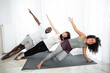 © sofiko14 - Happy sporty fit family doing gymnastic exercise in living room