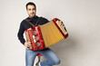 young man playing accordion on the white background