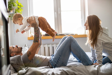 Wall Mural - Young family having fun together at home
