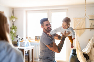 Wall Mural - Father playing with his little son at home
