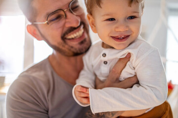 Wall Mural - Father looking after his small son at home
