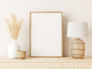 vertical poster art mockup with beige wooden frame, dried grass in vase, wicker basket lamp on empty