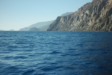 Calm blue sea, mountains and sky. A seascape with mountains at Turkey. Picturesque marine scenery.