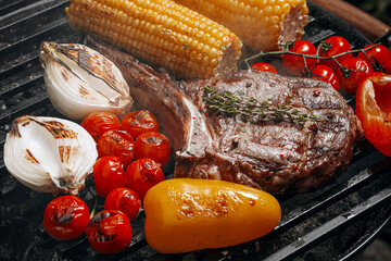 Wall Mural - barbeque steak on a black slate board