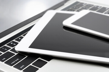 Wall Mural - collection of modern personal electronic devices: white smartphone, tablet and laptop in close-up