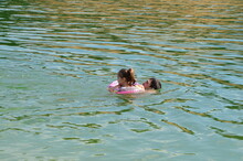 Daughter With Rubber Circle, Son And Father. Family With Two Children Bathes And Splashes With Enthusiasm In The Lake On Summer Vacation. Weekend, Outdoor Recreation, Family Enjoy The Rest.