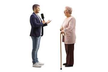 Wall Mural - Young male reporter interviewing an elderly citizen