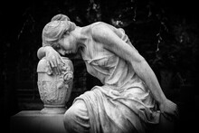 Sad And Weeping Woman Sculpture. Sad Grieving Expression Sculpture With Sorrow Face Down Thinking Crying. Black And White BW Photography.