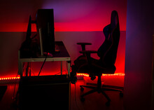 Modern LED Red Ambient Light Around Gaming Computer Set At Home. Home Decor Concept.