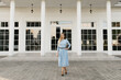 © ksyusha_yanovich - Attractive young girl on the background of the white house in a blue dress