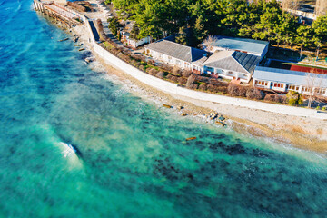 Wall Mural - Aerial view at sea coastline with buildings near ocean water, beautiful azure water, summer travel concept.