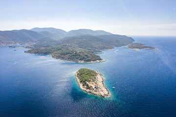 Wall Mural - Aerial drone shot of Host Island in Adriatic sea near town port of Vis Island in Croatia summer