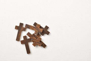Wall Mural - Pile of wooden crosses on white table