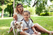 © iordani - young pretty caucasian mother walking with little cute daughter and dog fox terrier, lifestyle people concept