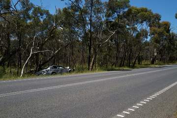 Smashed car left at the side of a country road