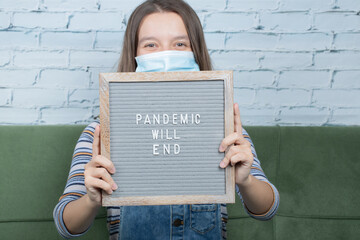 Young activist with a poster related to covid virus