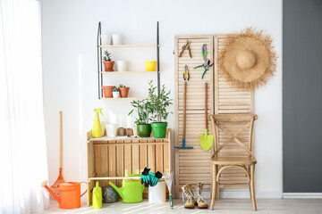 Canvas Print - Set of gardening supplies and houseplants in barn