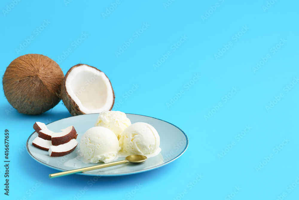 Plate with tasty coconut ice cream on color background