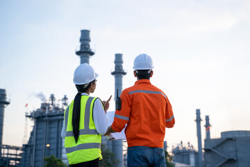 Aufkleber - Two engineers working with laptop at front oil and gas refinery plant industry factory.