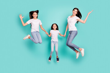 Sticker - Full length body size photo sisters jumping overjoyed smiling in casual outfits isolated vibrant blue color background