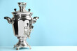 Traditional Russian samovar on light blue background. Space for text